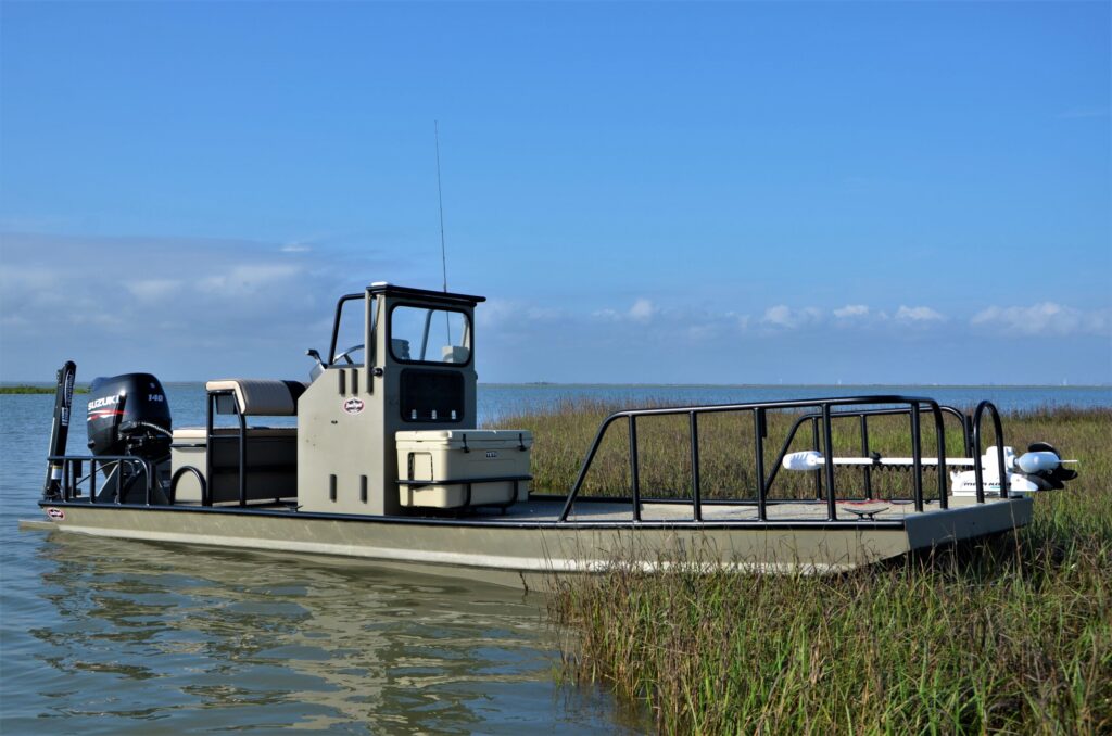 Boat Right Classic aluminum bay boat at the edge of a Texas marsh
