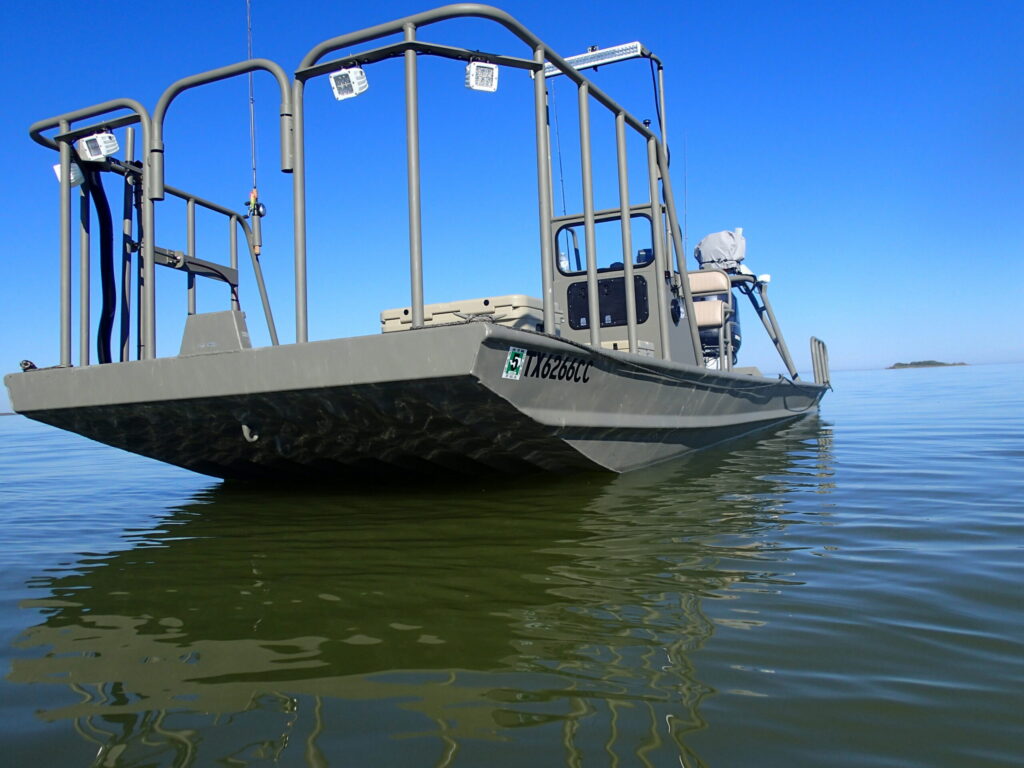 Boat Right flounder boat with a rail-mounted light rig on still water