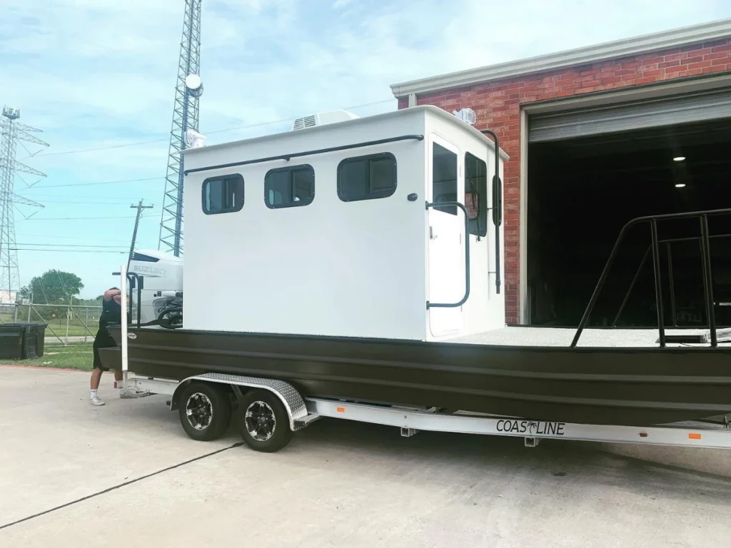 Aluminum cabin work boat by Boat Right on its trailer outside the shop