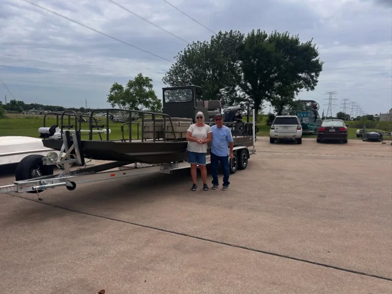Two owners in front of their olive Boat Right