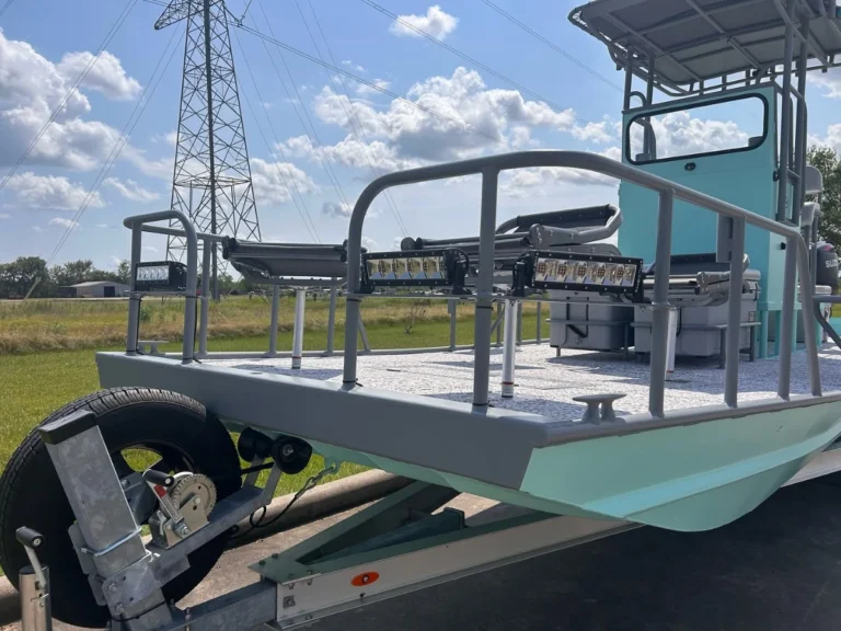 Flounder light rig on the bow rails of a teal boat