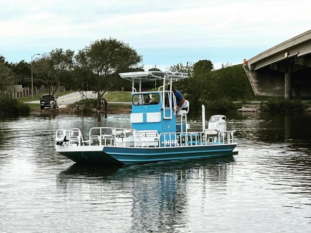 Light blue Boat Right with a T-top on the water