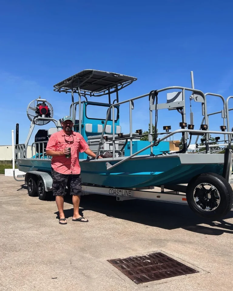 Owner leaning on his teal Boat Right with a T-top