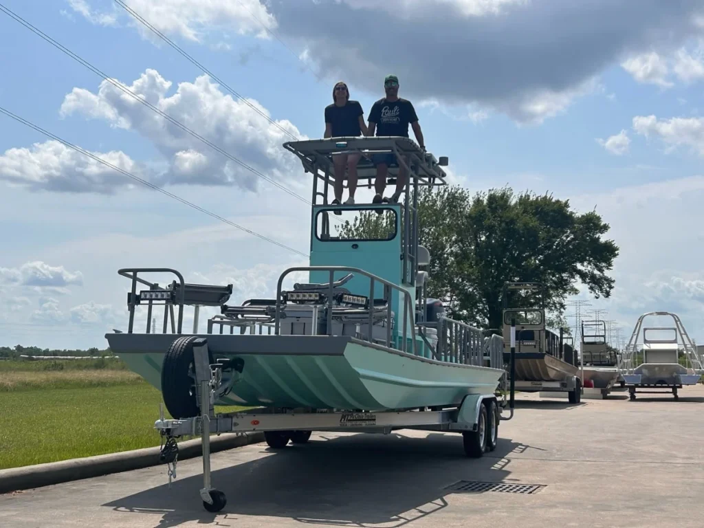 Owners standing on the tower of a seafoam Boat Right at pickup