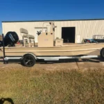 Tan Boat Right on its trailer outside the shop