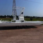 White Boat Right with a tower on its trailer
